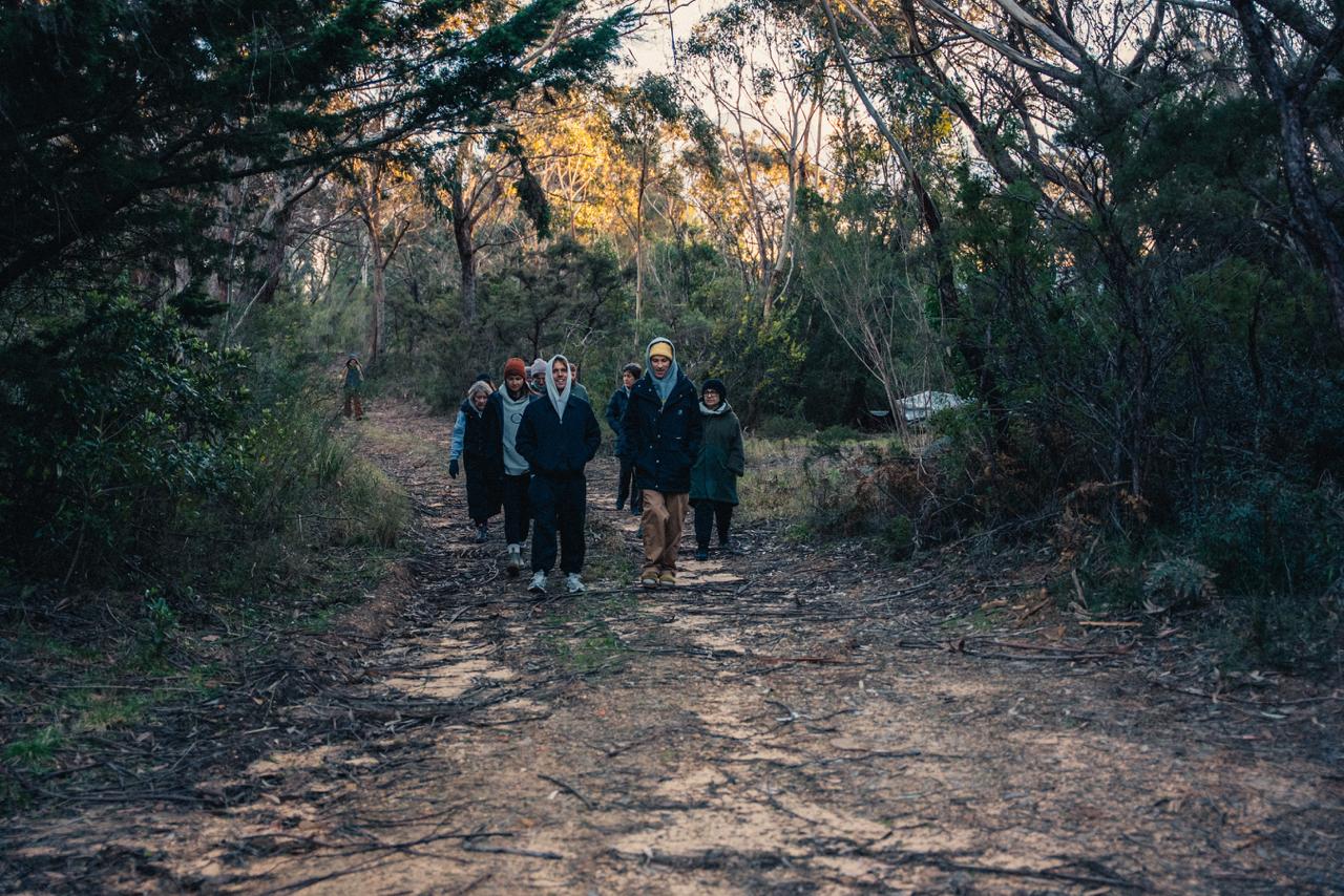 People walking together through Australian bushland.
